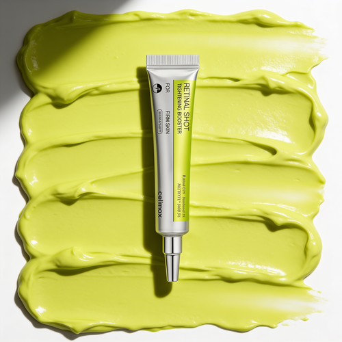 Tube Celimax Vita-A Retinal Shot vu de dessus sur une texture de creme chartreuse